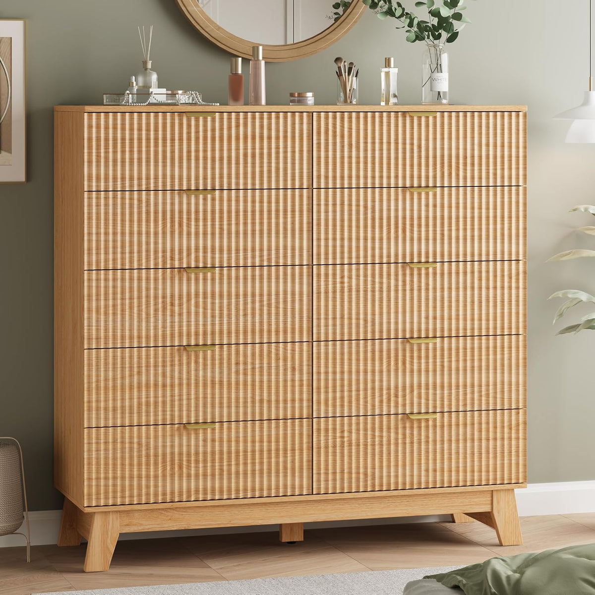 Straight-on close crop highlighting vertical ribbed drawer texture and slim gold handles on a light oak tall chest.