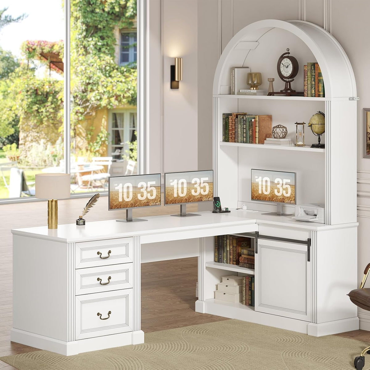 White L-shaped desk arranged beneath an arched hutch in a bright room with large window and three monitors