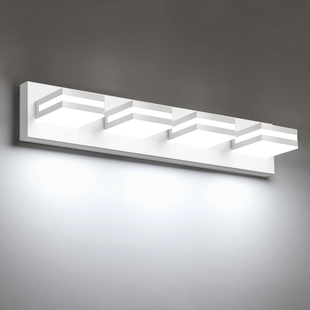 White finish vanity light showing four glowing square LED modules on a rectangular backplate.