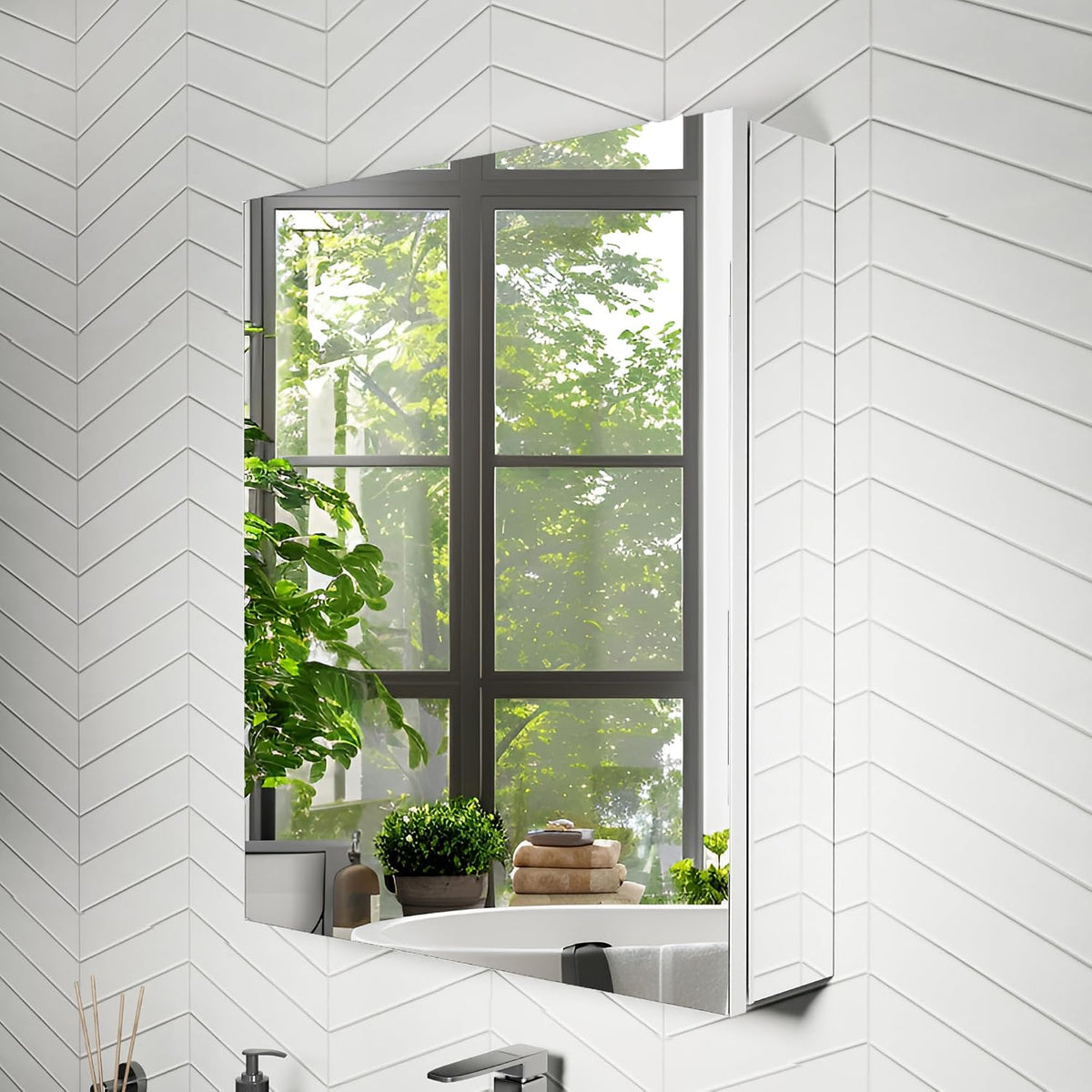 Beveled mirror edge reflecting a large window and greenery, set against white chevron tile.