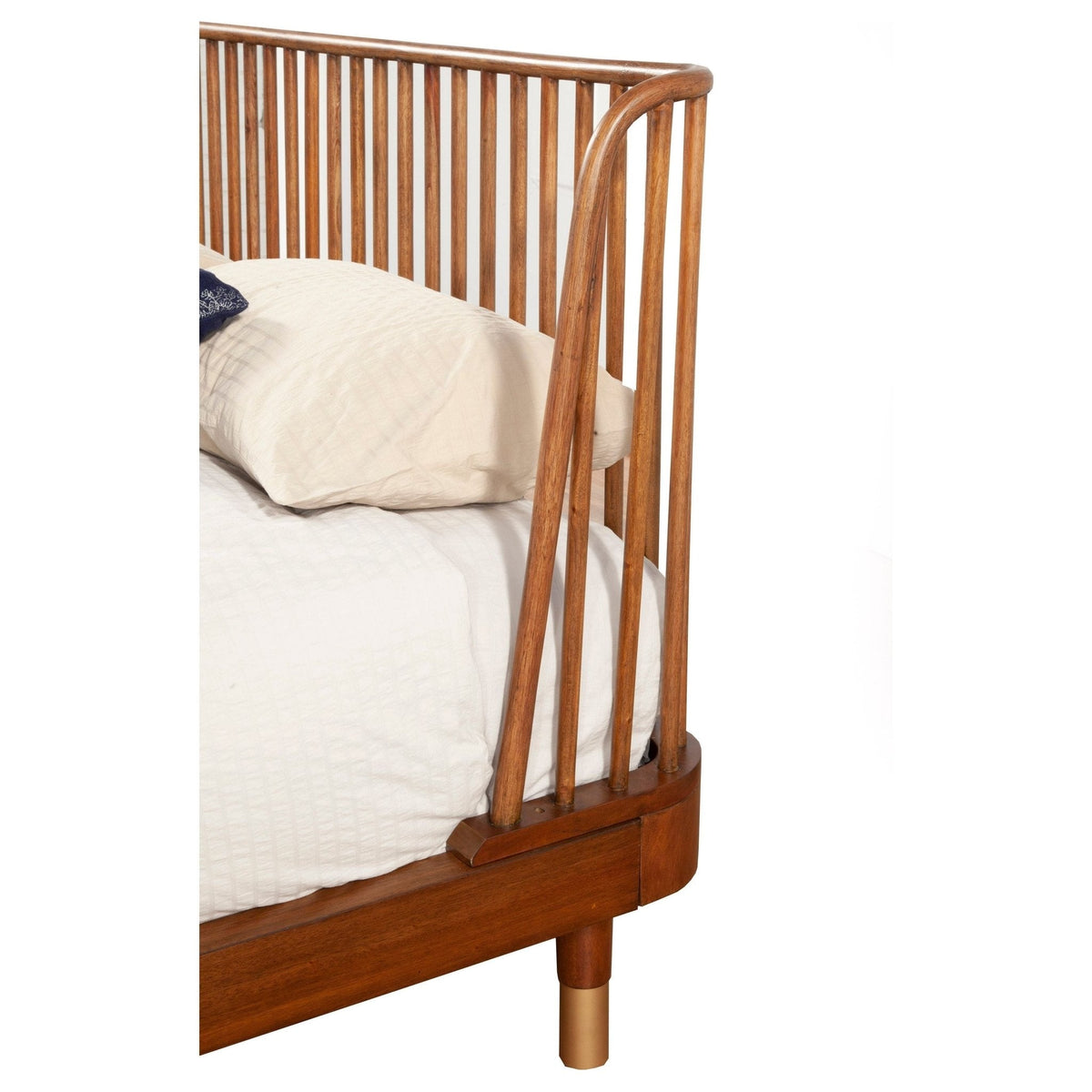 Close-up of the warm brown slat headboard, side rail and bed leg