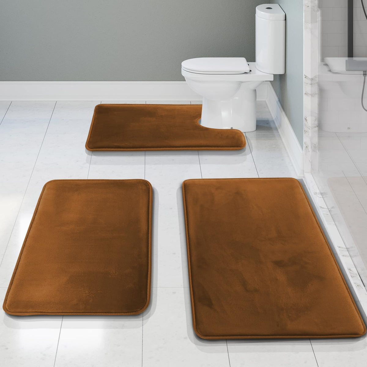 Three-piece set arranged on white tile: a brown U-shaped rug by the toilet and two brown rectangles in the foreground.
