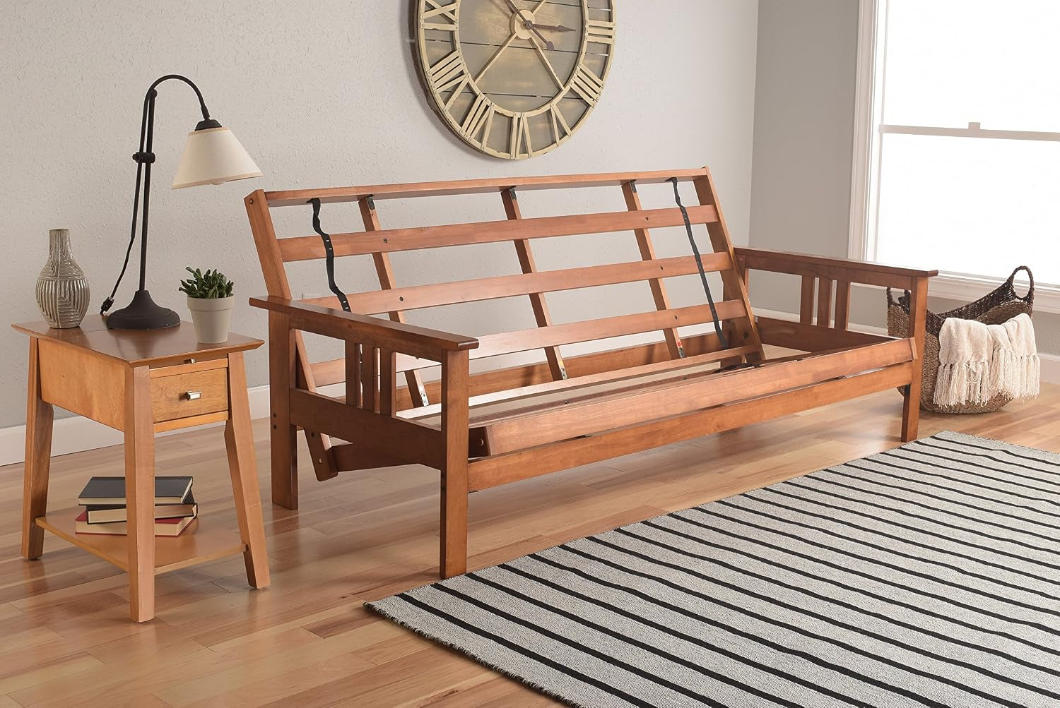 Wood futon frame shown open with slats and supporting hardware, mattress removed