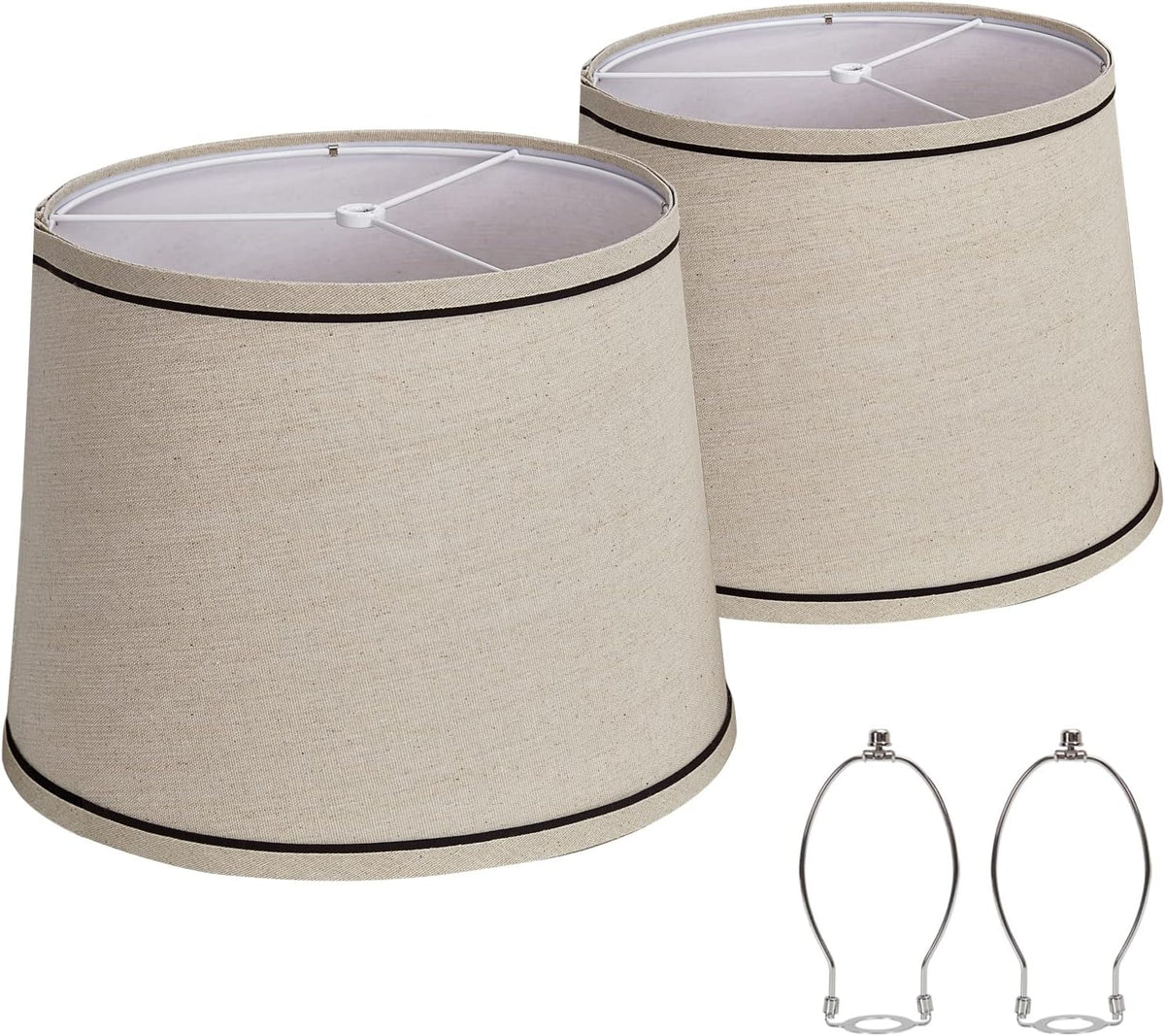 Pair of tapered beige fabric shades with thin dark trim along top and bottom edges and two chrome harps
