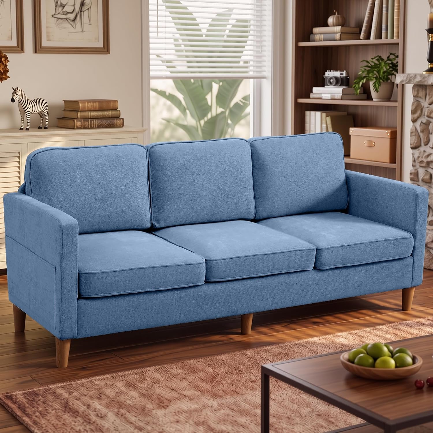Light blue three-seat sofa with wooden tapered legs placed in a cozy living room scene
