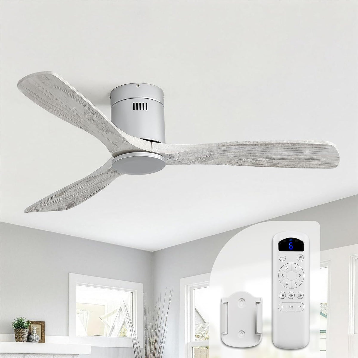 Three-blade ceiling fan in a neutral room showing weathered gray wood blades and white motor, remote control pictured at