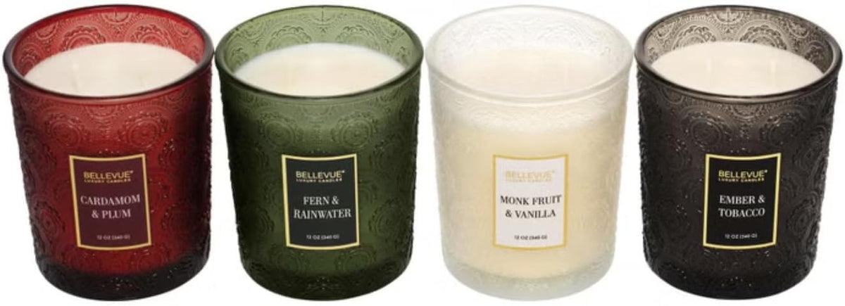 Top-down view of four embossed glass jar candles without lids showing the wax surfaces inside each jar