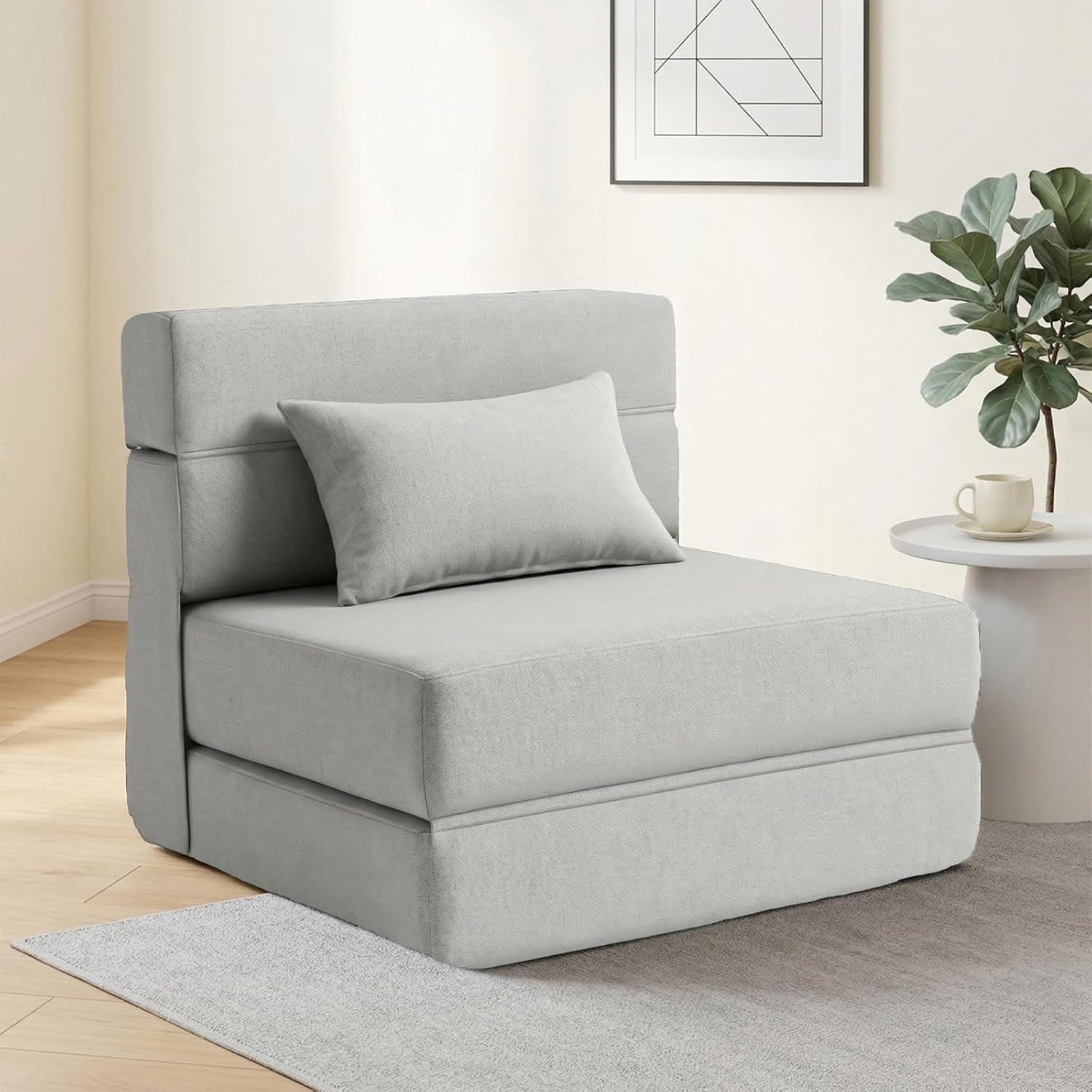 Light gray single-seat configuration of the folding twin sofa bed in a cozy room next to a side table.