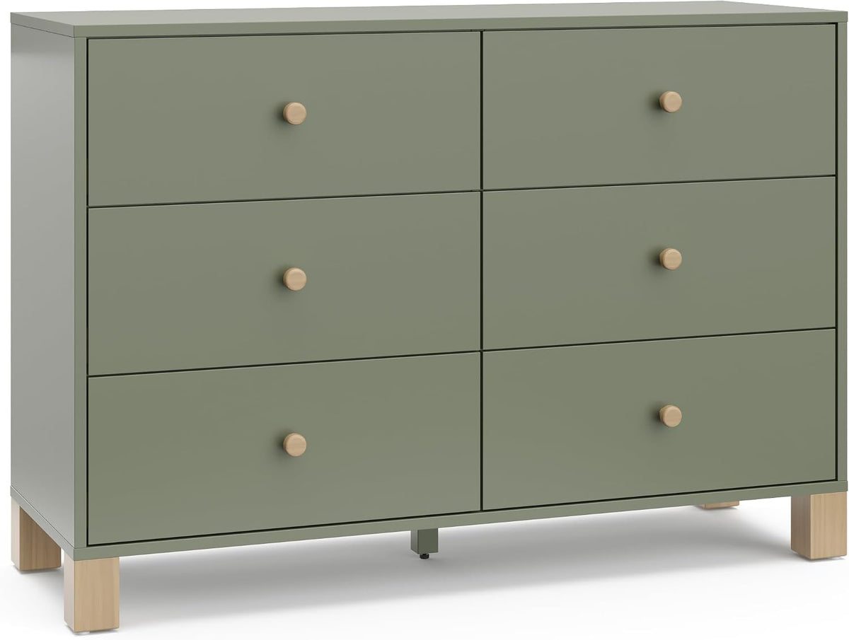 Front view of a six-drawer low dresser in sage green with round wood knobs and block wood legs.