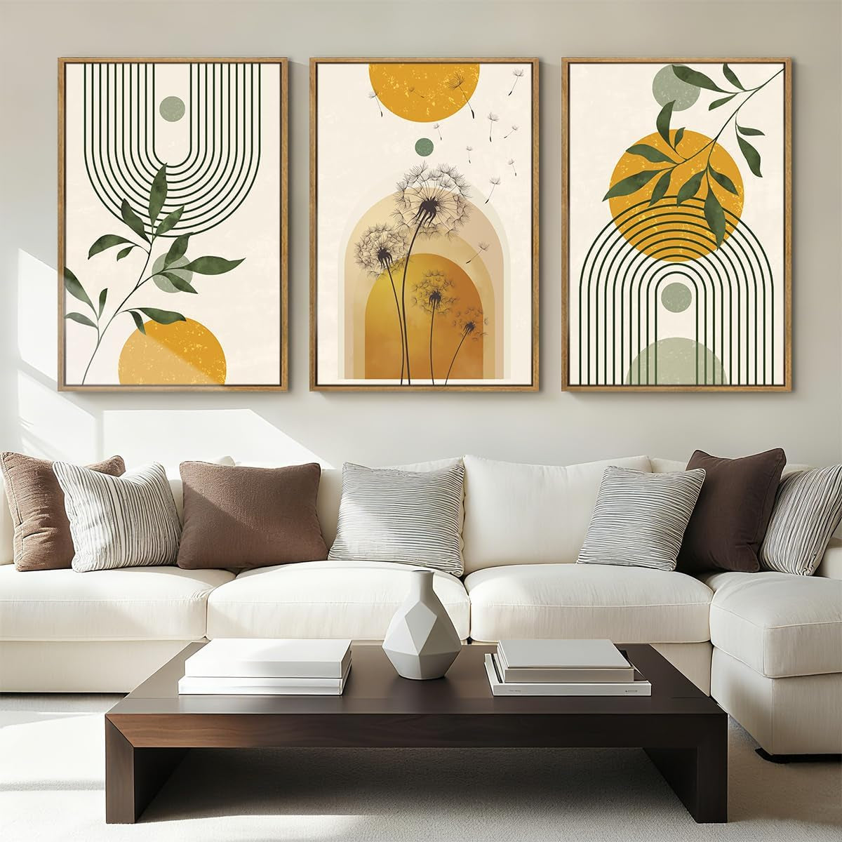 Neutral living room with white sofa and three framed geometric botanical prints above a dark coffee table.