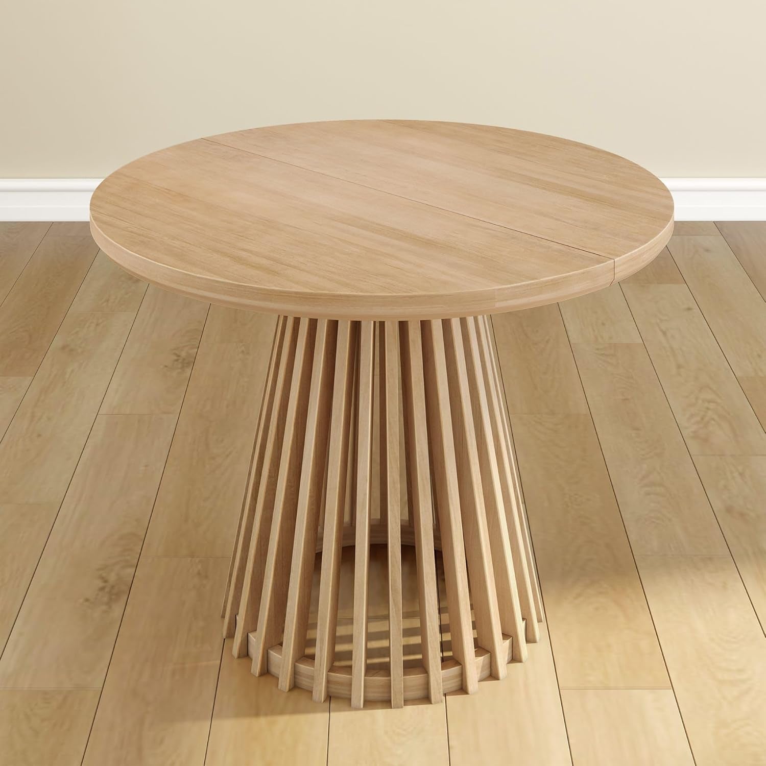 Front view of a round light-wood dining table with a vertical slatted pedestal base.