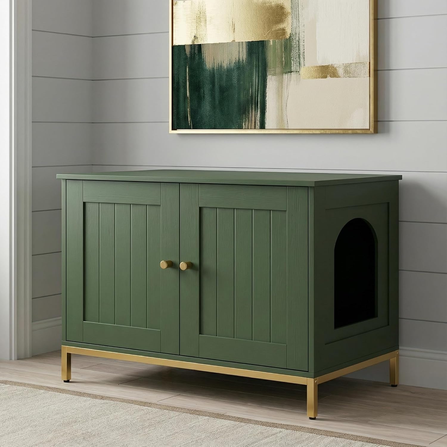 Green cat litter cabinet with gold legs shown against shiplap wall and framed art