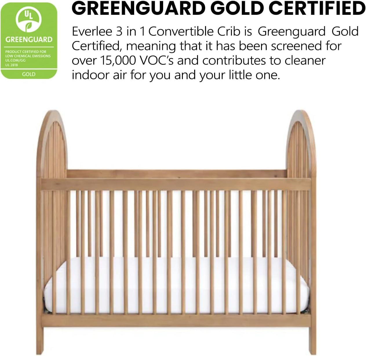 Front view of the honey wood crib with rounded arch ends and a Greenguard certification badge above