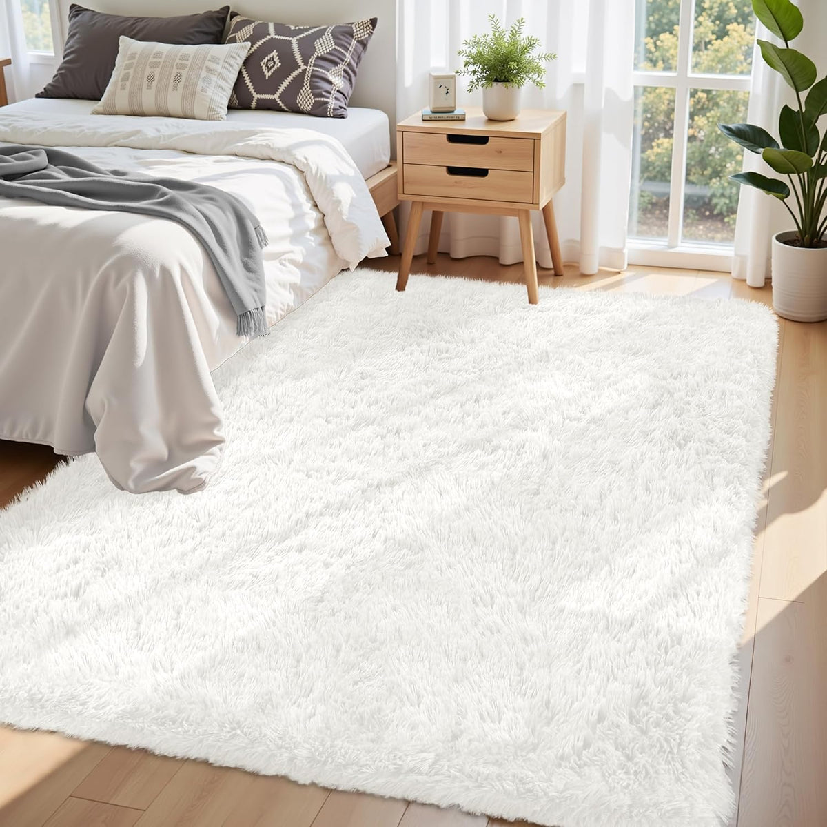 White shag area rug under bedside and nightstand in a bright bedroom scene
