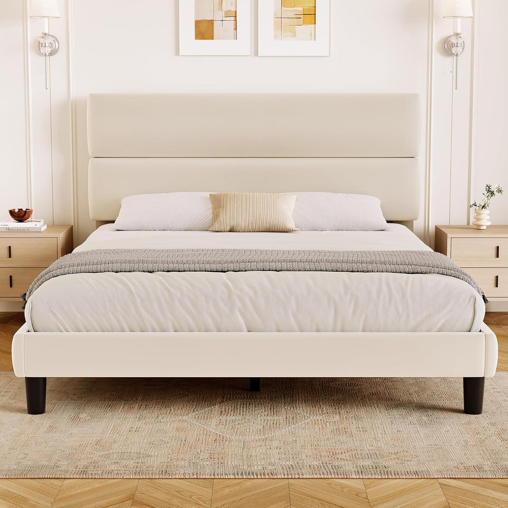 Front bedroom view of a cream upholstered platform bed with a tall two-panel headboard.