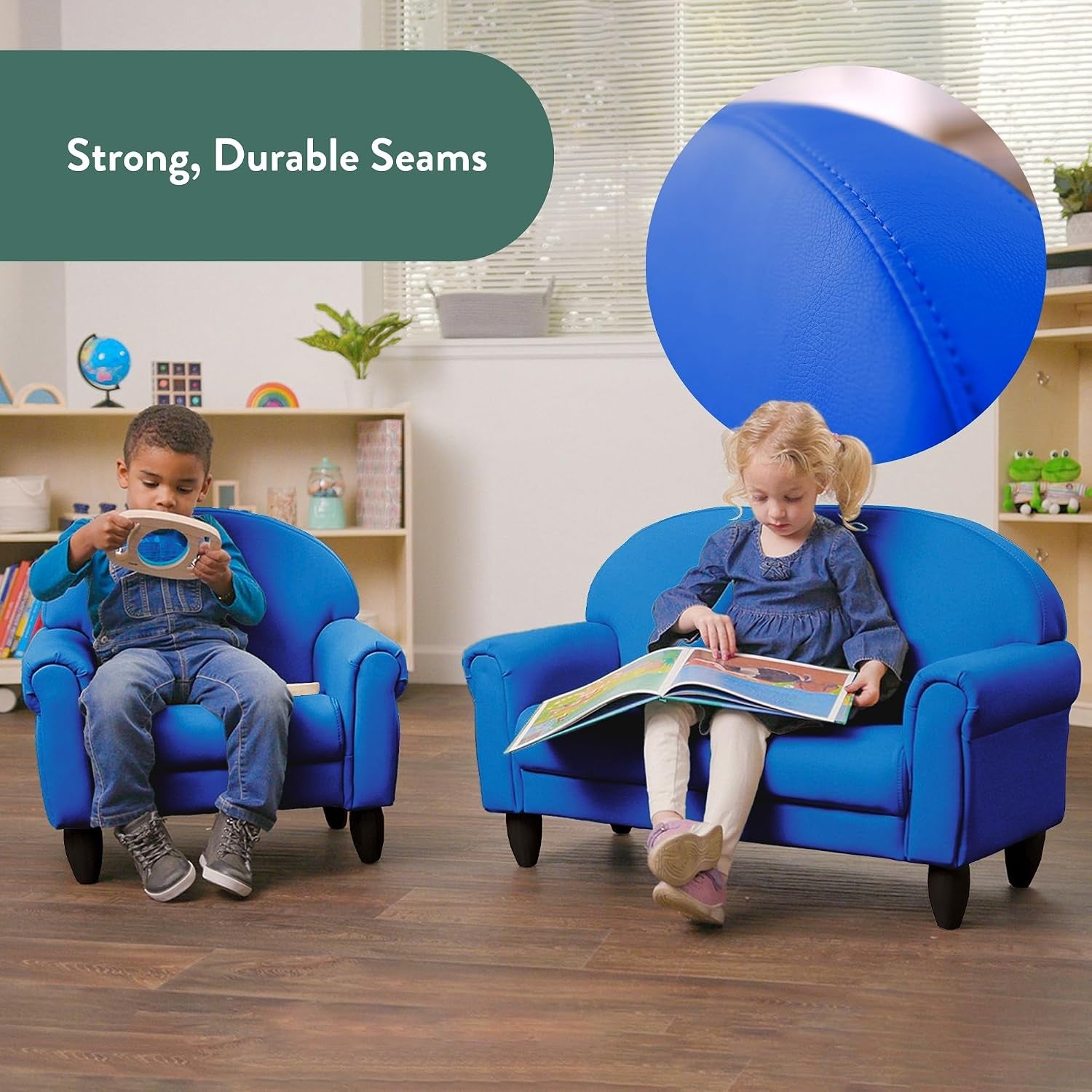 Two children sitting on matching blue kid-sized chair and sofa in a playroom