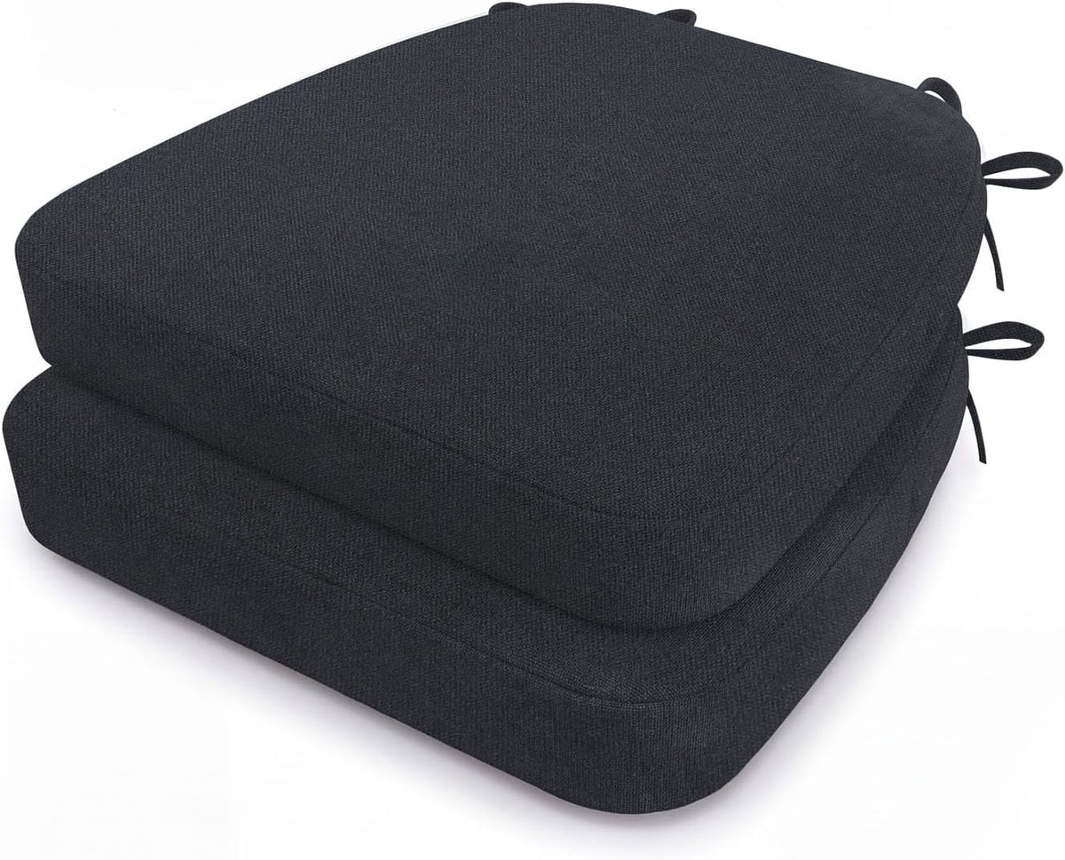 Two dark charcoal D-shaped seat cushions stacked, visible fabric texture and tie straps at the back corners.