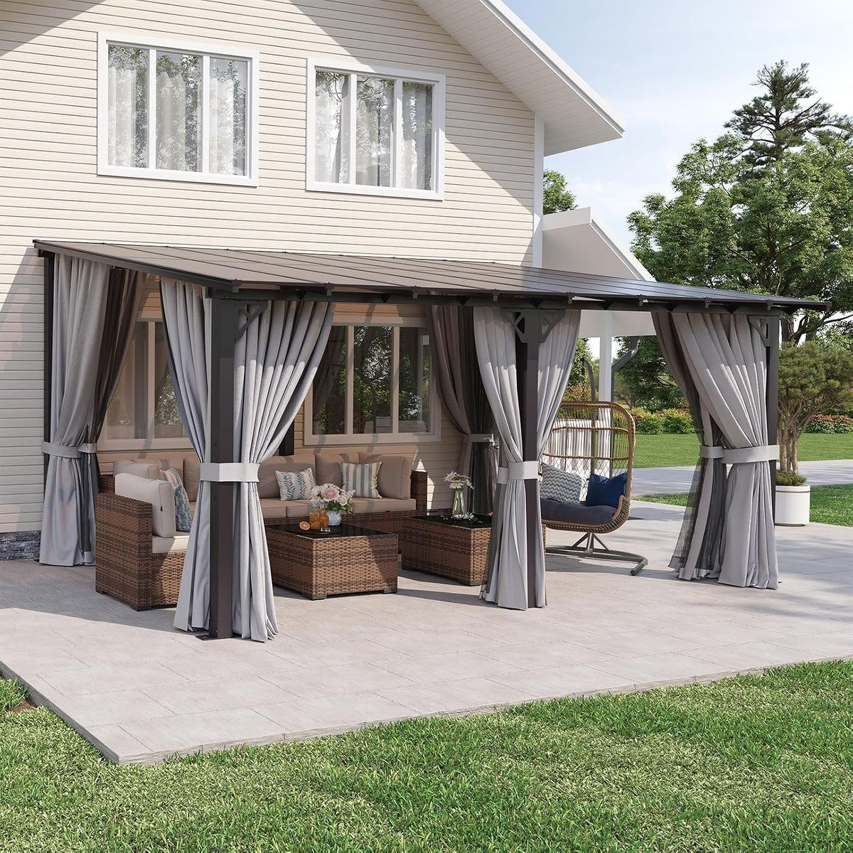 Wide front view of the wall-mounted pergola spanning the patio with gray curtains and a swing chair visible inside.
