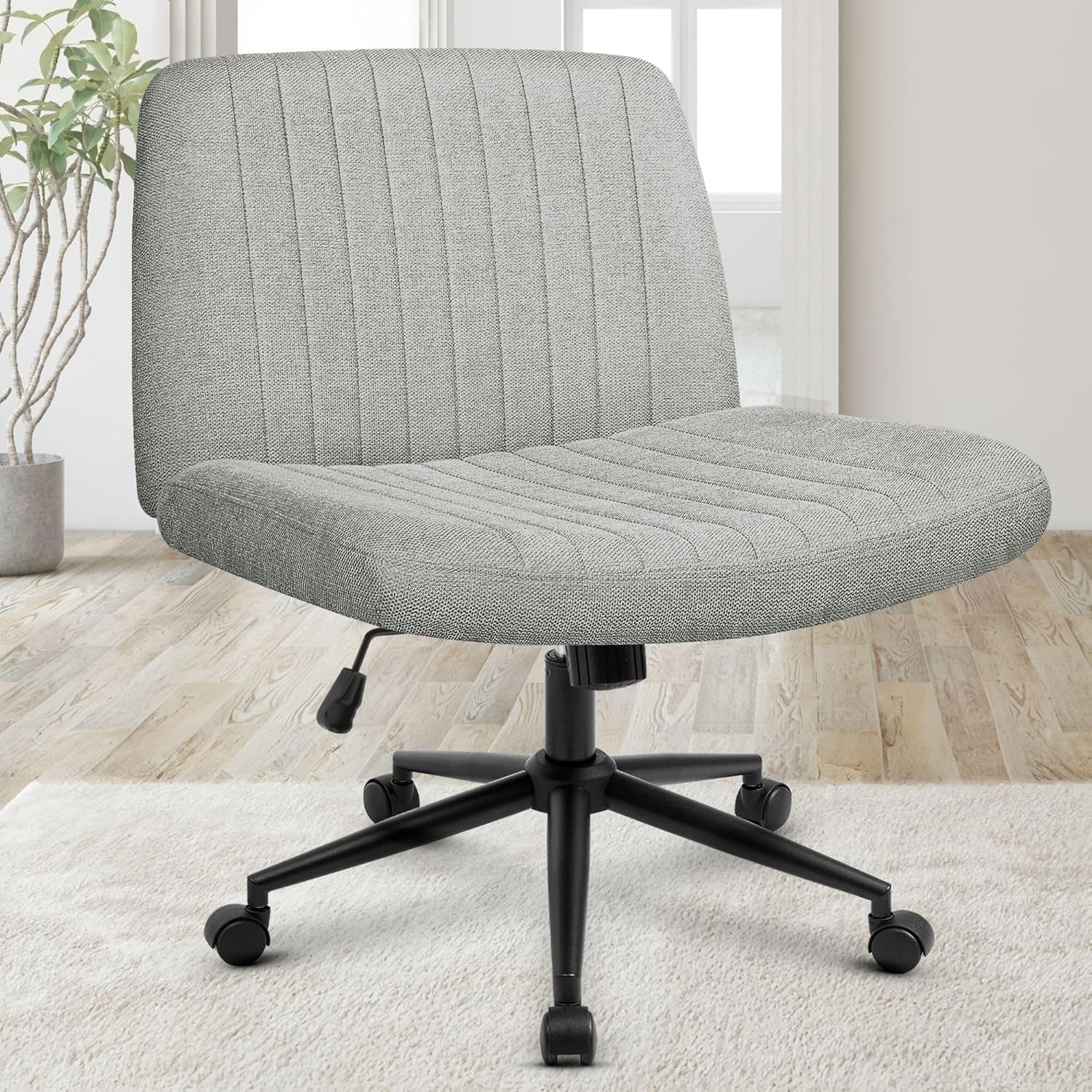 Front three-quarter view of a light heather-gray woven swivel chair with vertical channel stitching and black caster base.