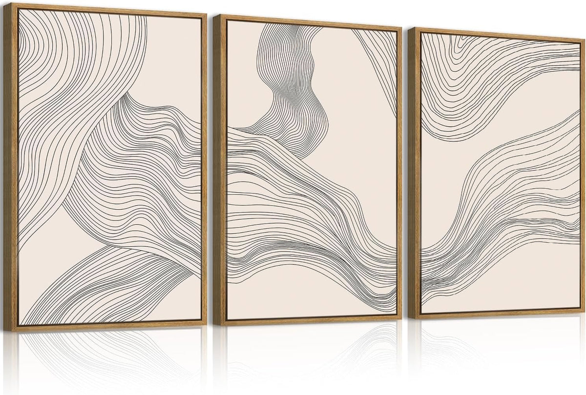 Three framed vertical canvases with flowing black line abstract designs on a pale background.