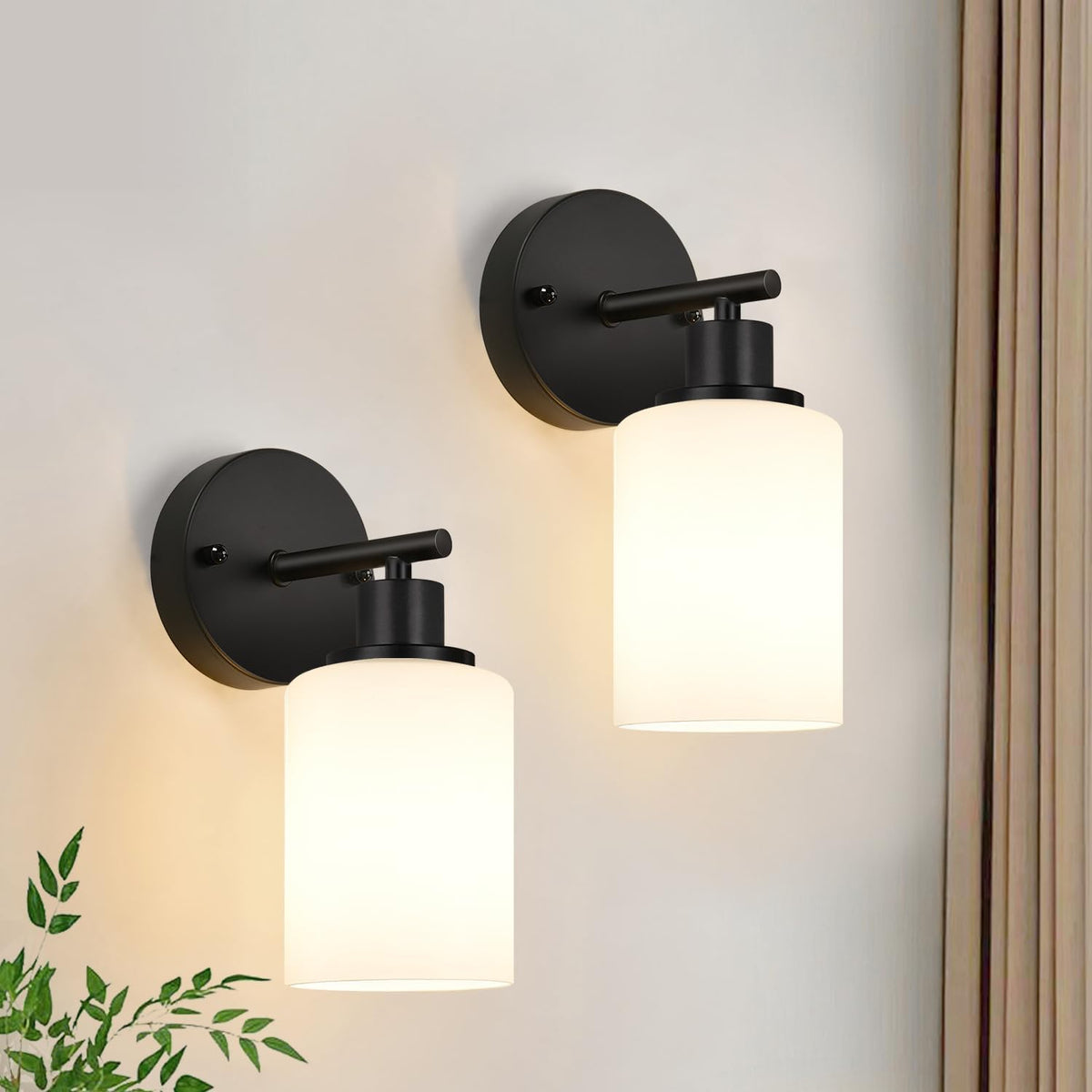 Two black wall sconce lights with white cylindrical shades mounted on round backplates.