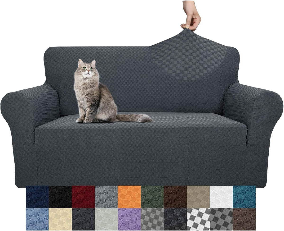Dark gray jacquard stretch sofa cover on three-seat sofa with a grey cat and color swatches below