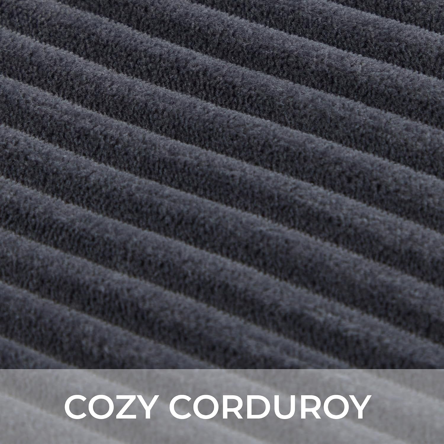 Close-up of dark gray ribbed corduroy fabric showing plush, raised ridges.