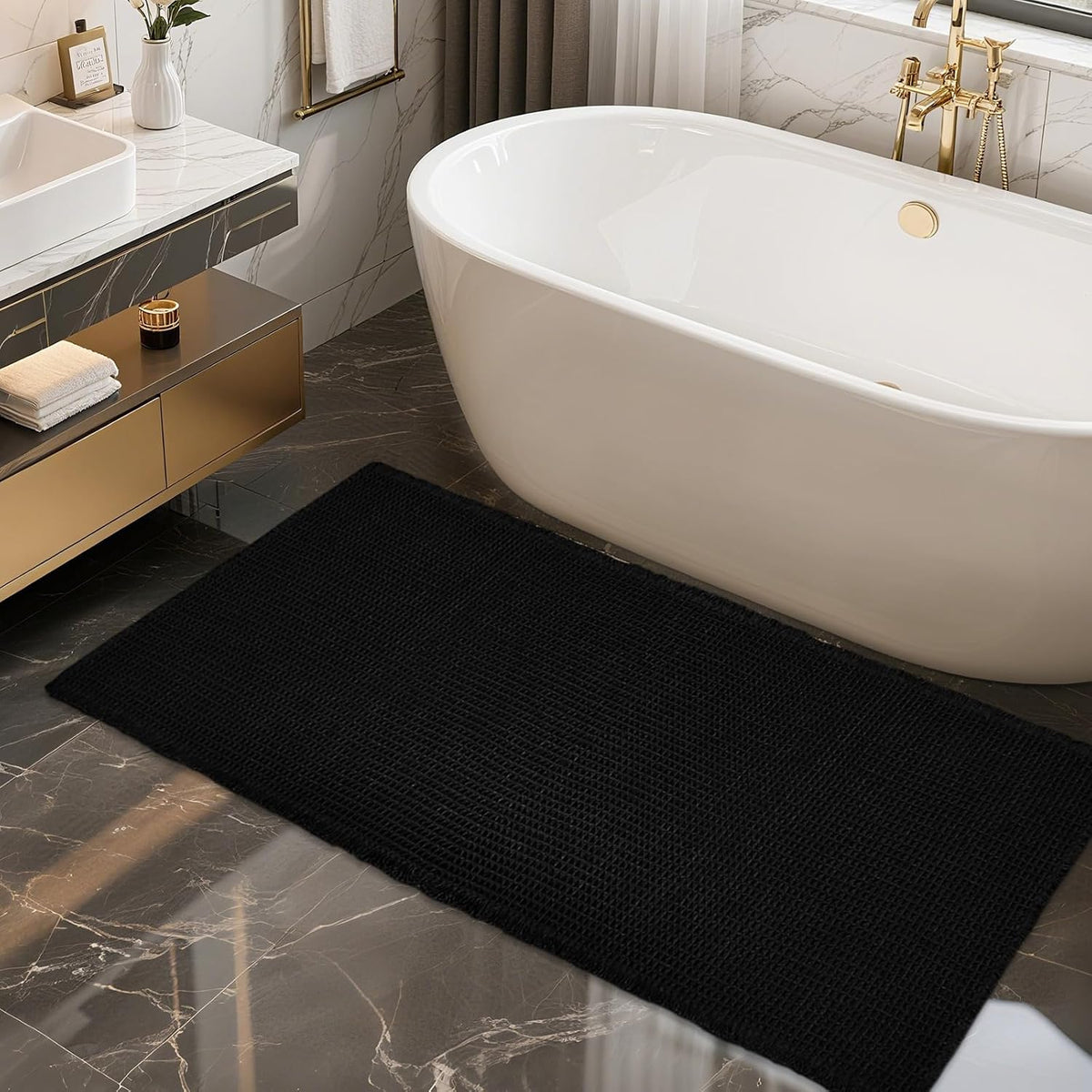 Black waffle-texture rectangular mat placed along the side of a white freestanding bathtub