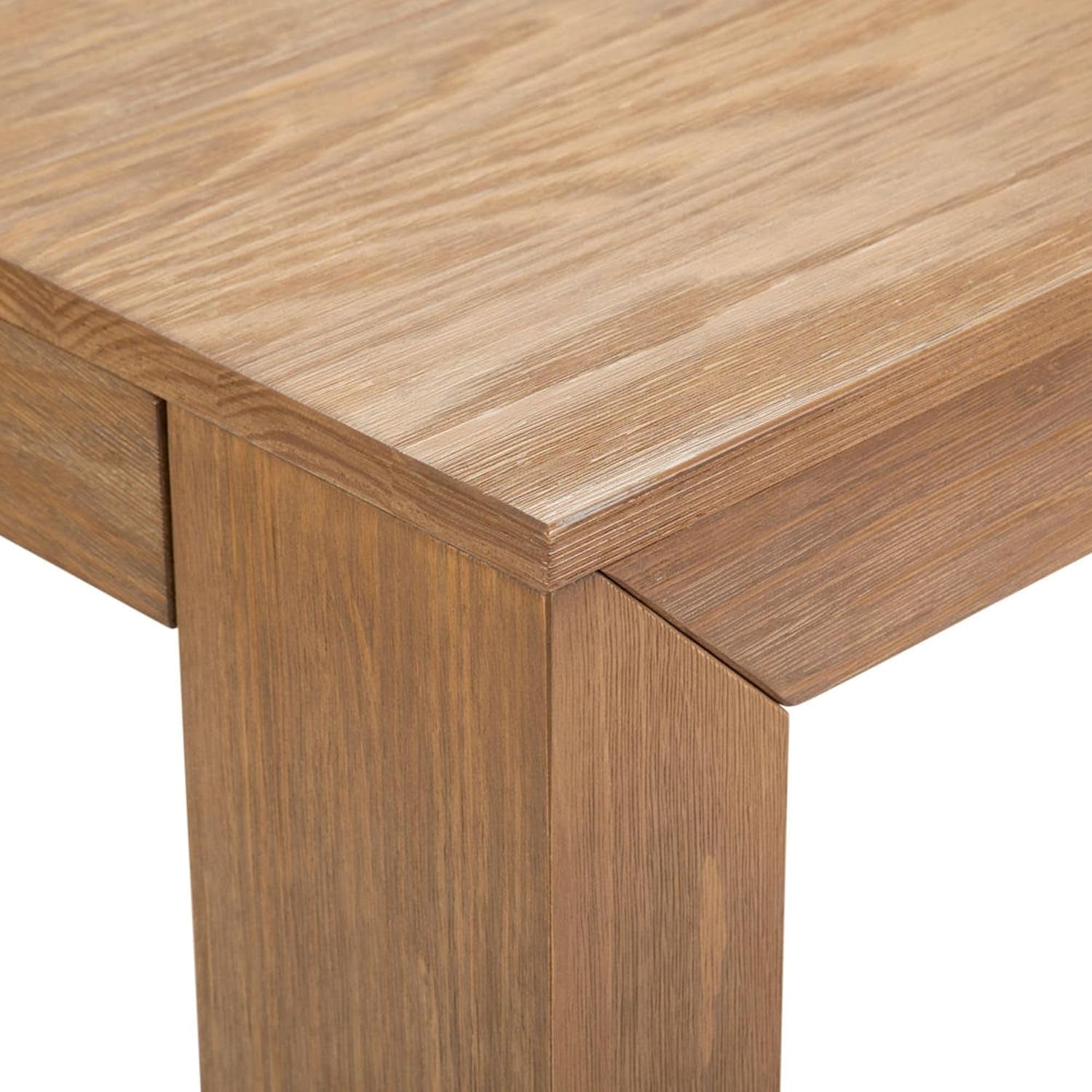 Close-up corner of a pine table top and square leg showing wirebrushed wood grain and mitered joint.