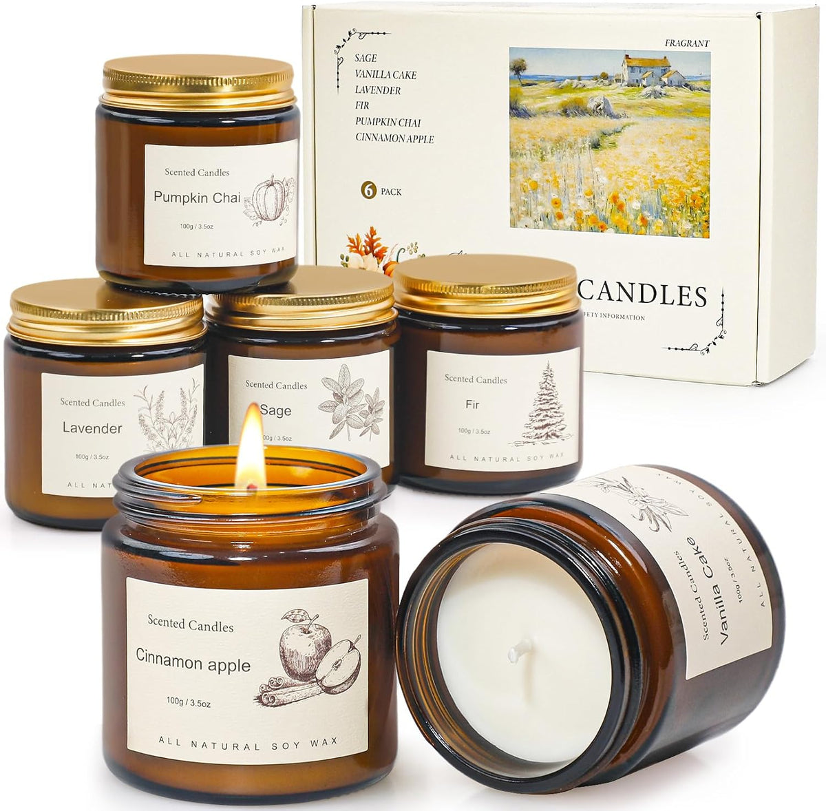 Angled view of several amber jar candles with one lit in front and one jar tipped to show the unlit wax.