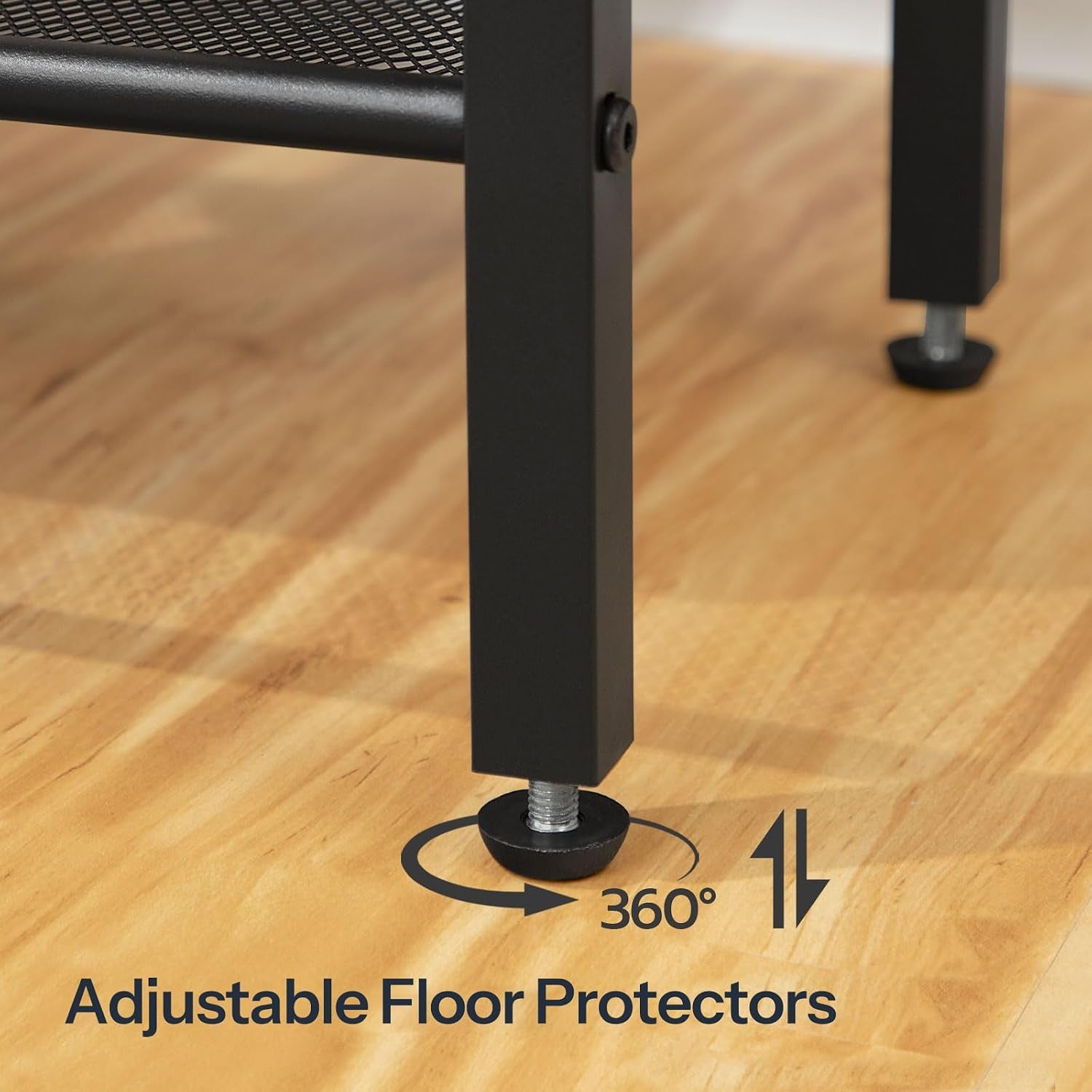 Close-up of the table's black metal leg showing an adjustable threaded floor protector on wood floor