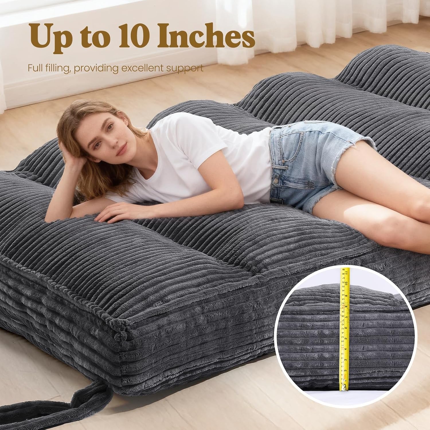 Close-up side view showing the 10-inch thickness of the grey futon mattress with measuring tape