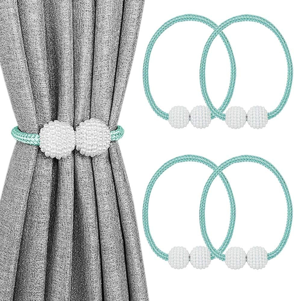 Gray curtain held by a mint-green braided tieback with two textured white pearl balls.