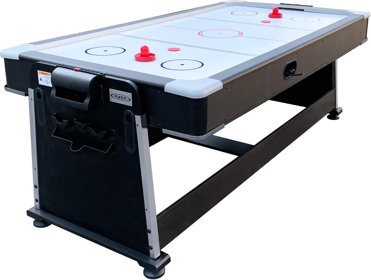 Air hockey surface installed on the table showing white rink markings, red pushers and black outer frame
