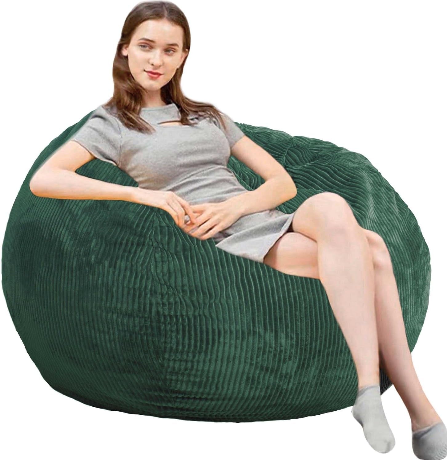 Side view of a woman seated on a dark green corded round bean bag chair.