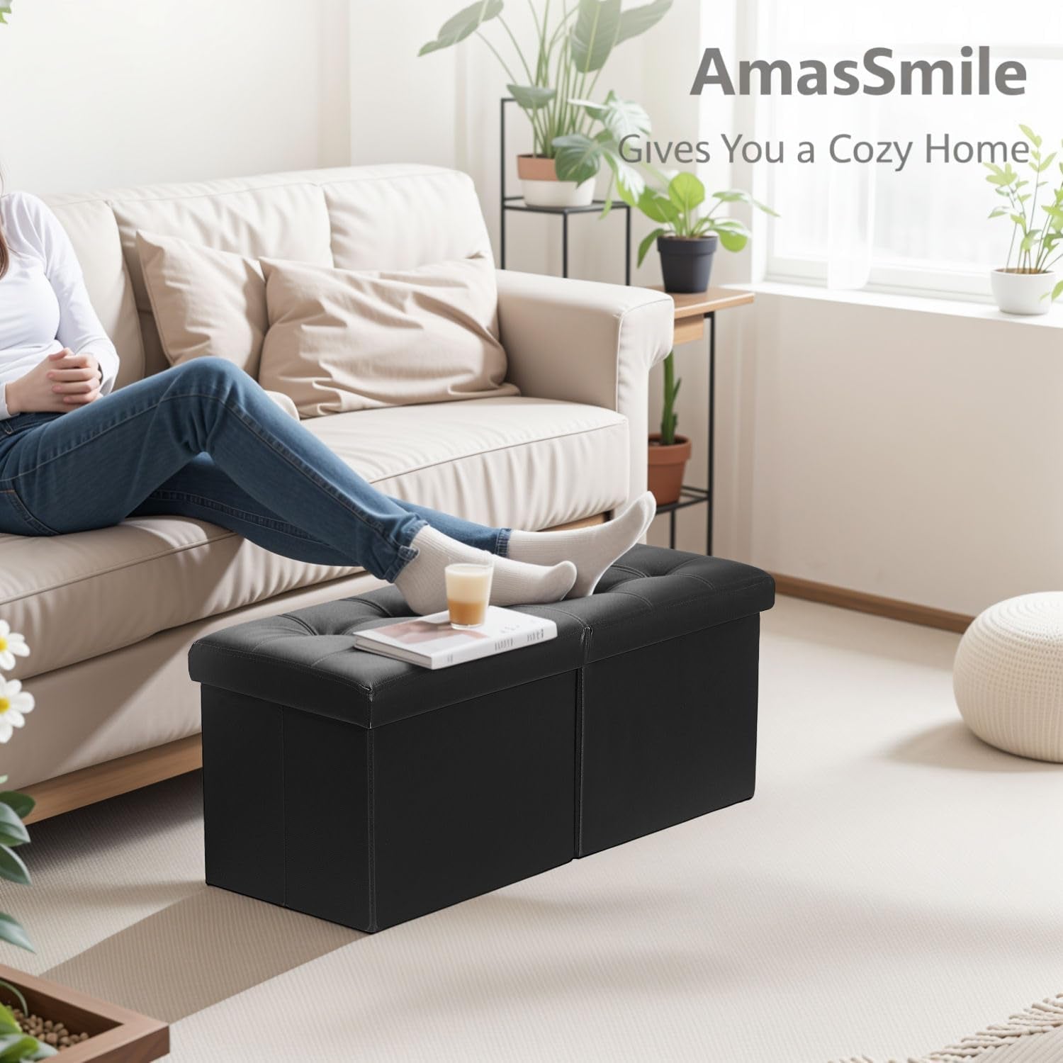 Black tufted leather ottoman placed in a living room setting with a person resting feet on it