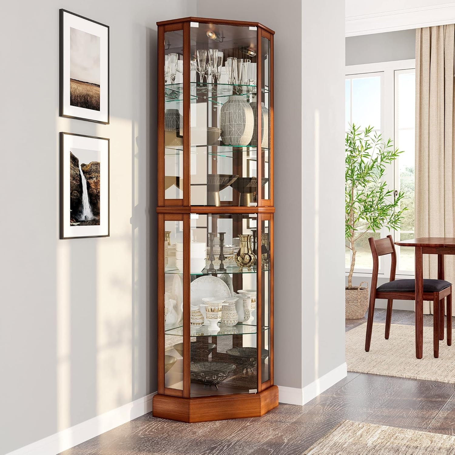 Oak finish corner display cabinet angled in a dining corner with glassware on shelves and natural light