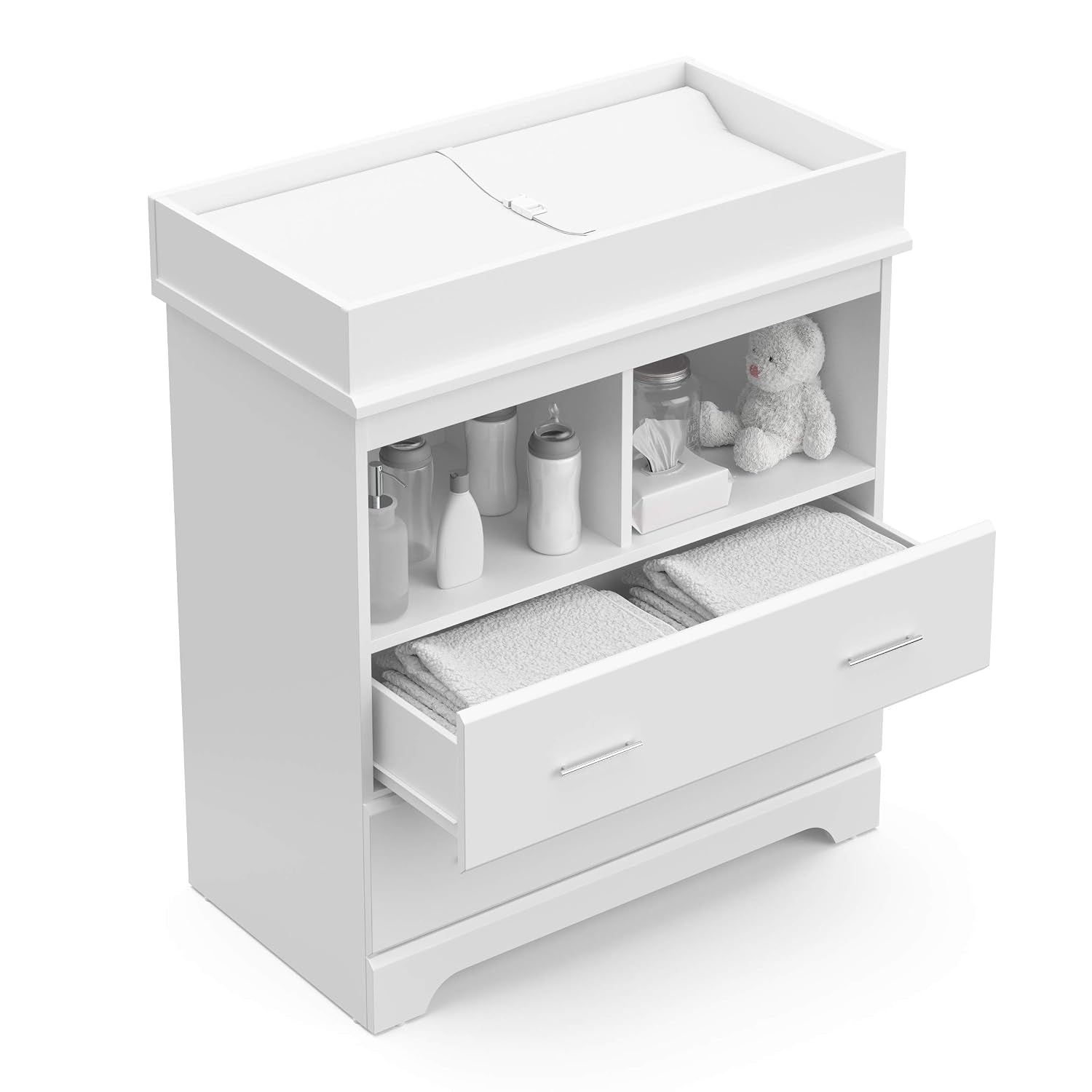 Top view of white changing chest with removable topper and open top drawer displaying folded towels and nursery bottles