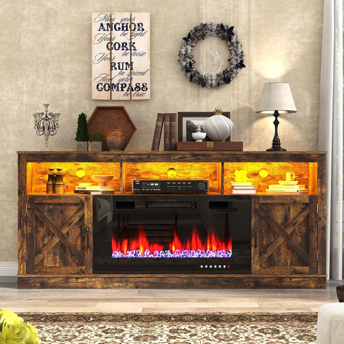 Rustic dark-brown console front showing X-cross barn doors, glowing upper shelves and colorful electric flame bed.