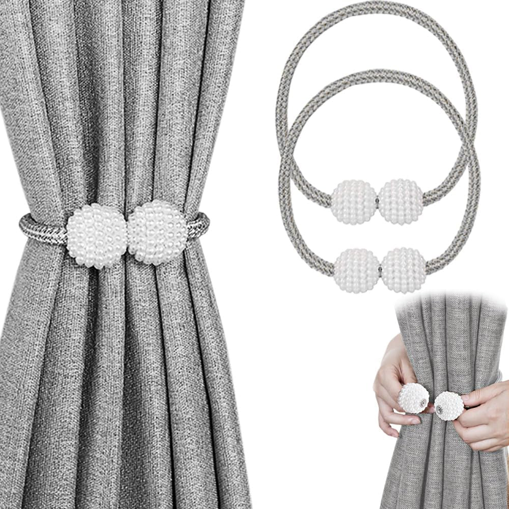 Gray curtain secured by a silver-gray braided tieback with two white textured pearl ball magnets; inset shows hands closing