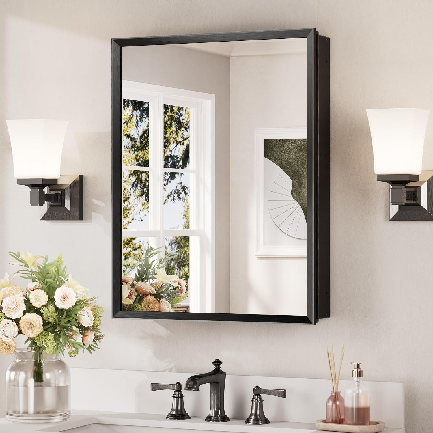 Wall-mounted mirrored medicine cabinet with a black frame reflected above a bathroom sink
