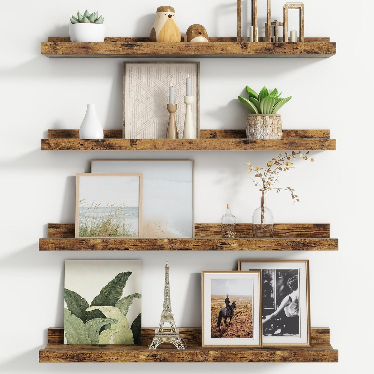 Three darker rustic wood floating ledges arranged with framed photos and small decor pieces.