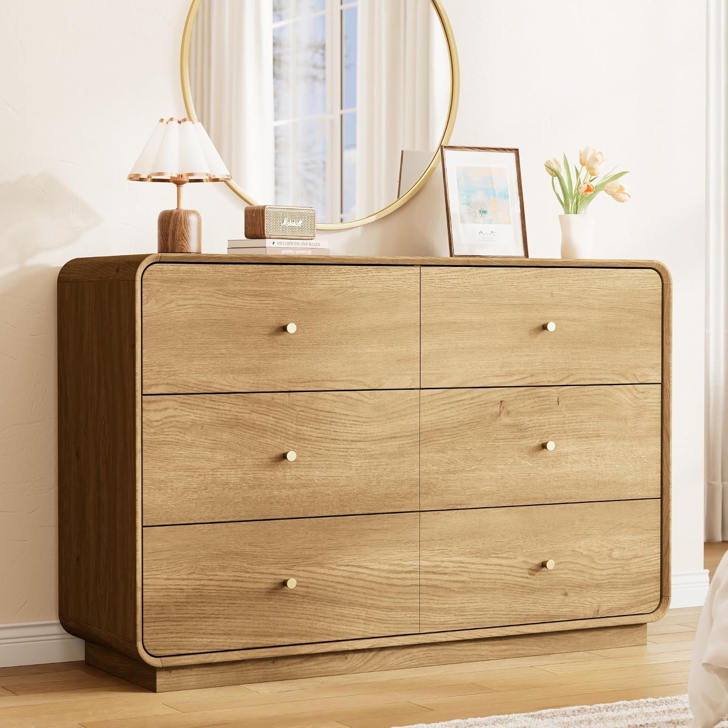 Close front view of oak 6-drawer dresser showing gold circular knobs and rounded corners