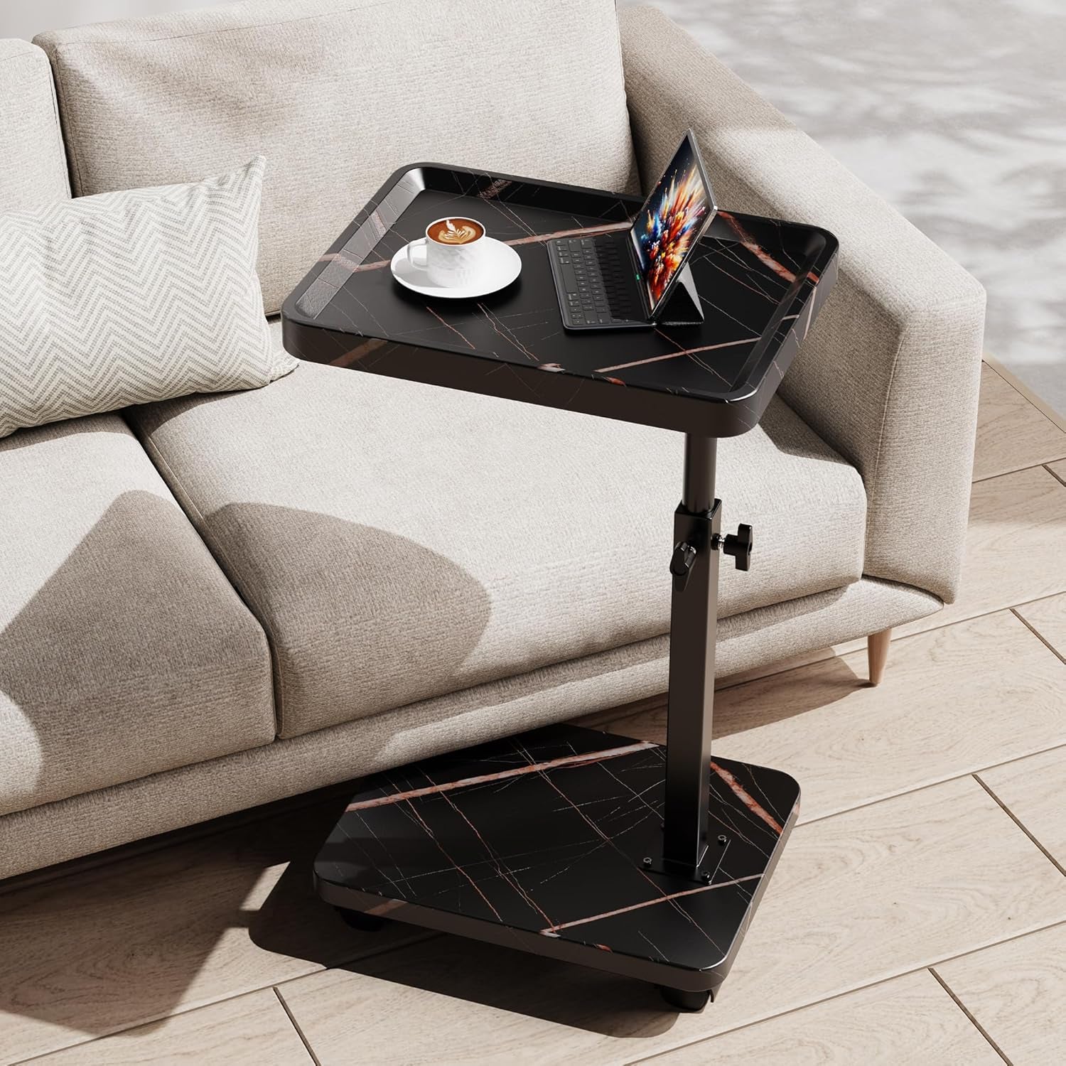 Same C-shaped adjustable end table in black marble-look finish next to the same beige sofa.