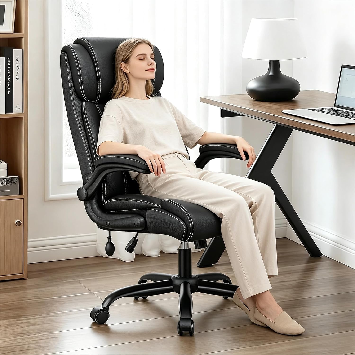 Woman sitting relaxed with eyes closed in the high-back chair beside a desk and lamp in a bright room.