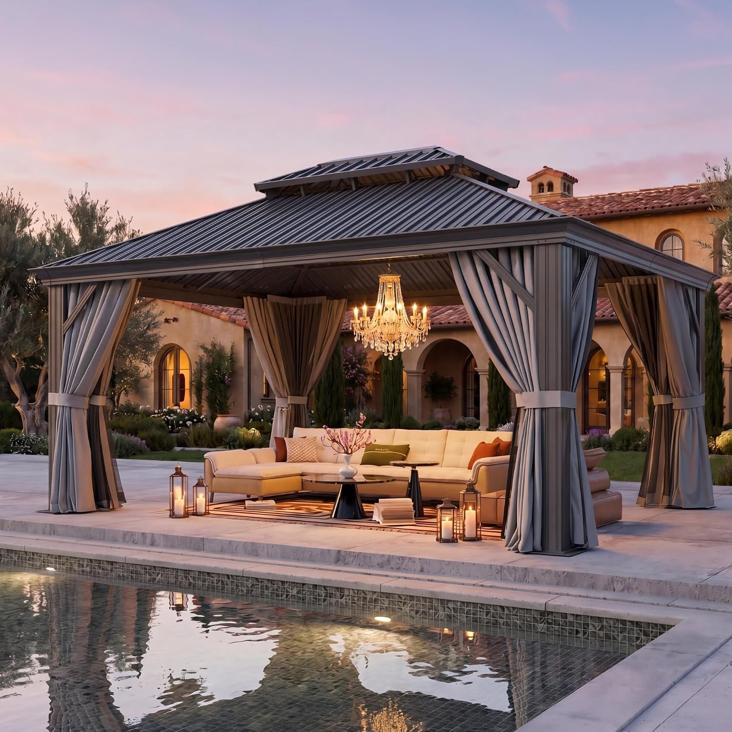 Gray hardtop gazebo beside pool at dusk with tied curtains and chandelier-style light inside