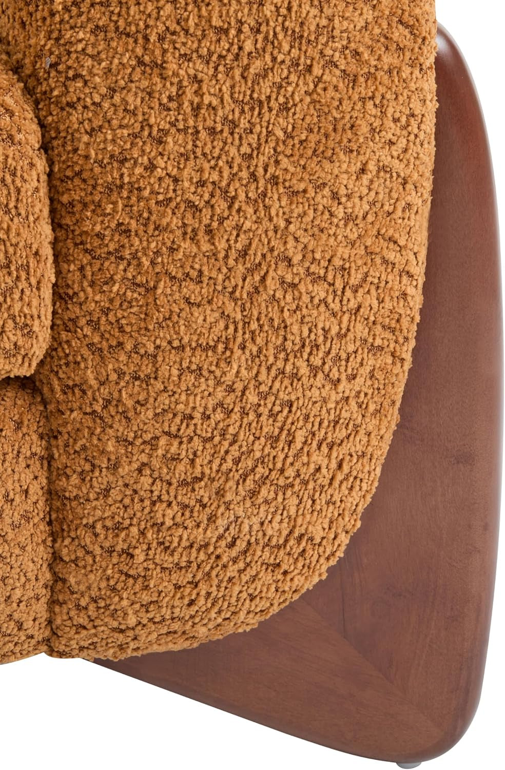 Tight detail of the rounded upholstered arm meeting a dark wooden tapered leg panel.