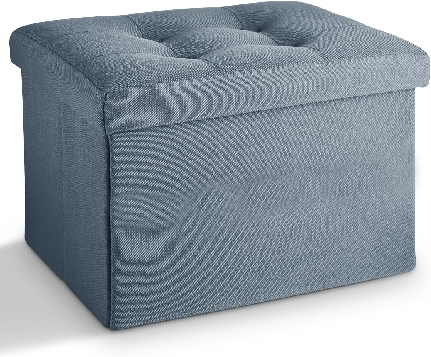 Light blue fabric storage ottoman with tufted cushioned top, photographed on a white background.