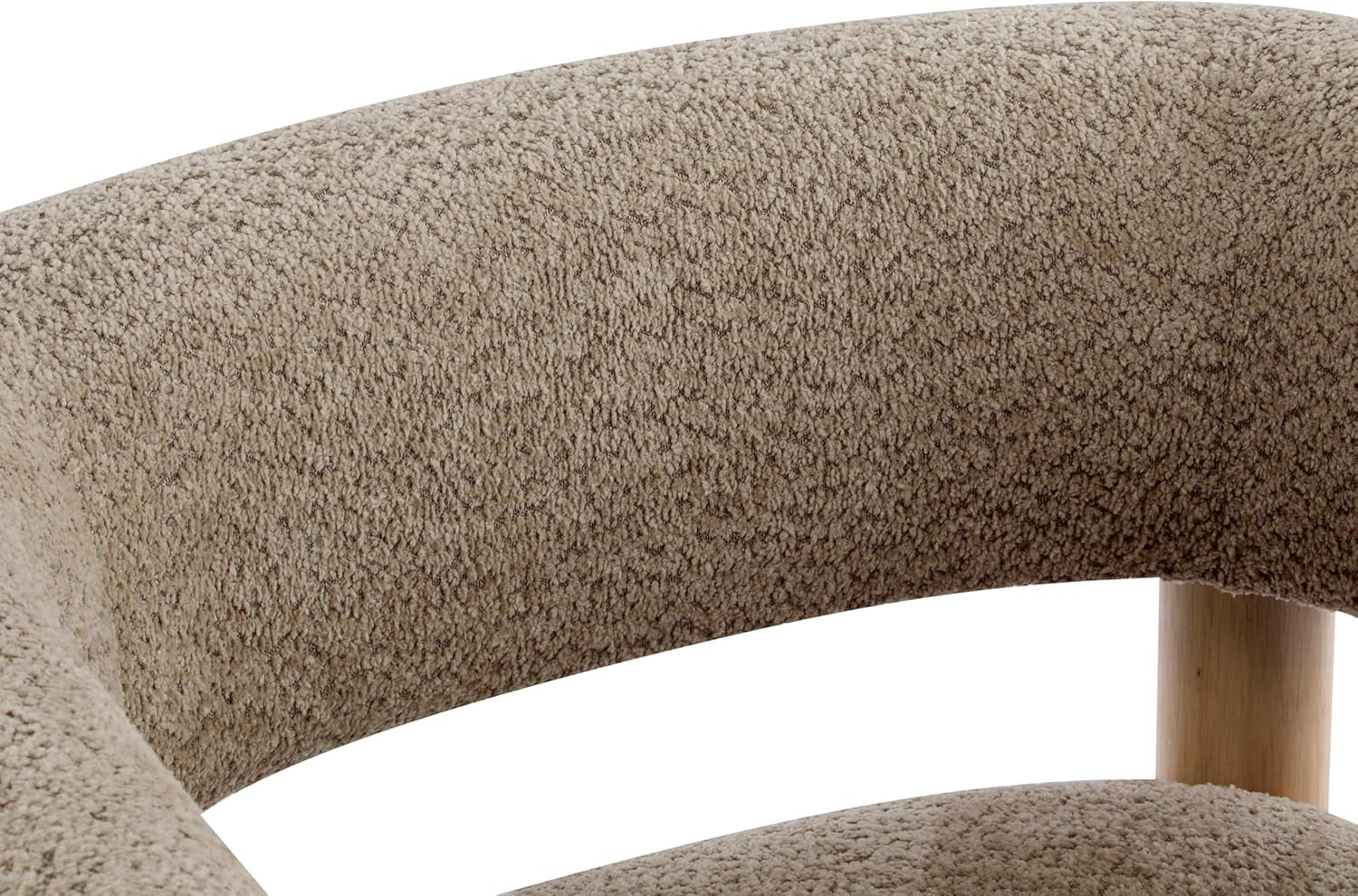 Close-up of the chair's curved back upholstery and a light wood support post, boucle texture visible
