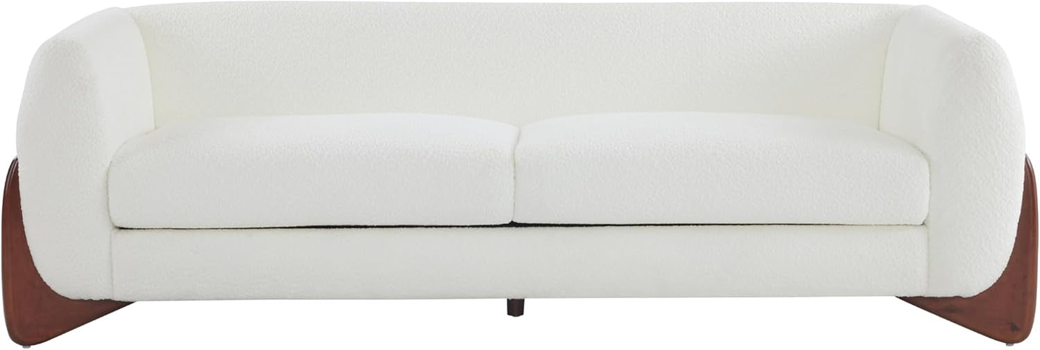 Frontal close view of the white bouclé three-seat sofa showing removable seat cushions and tapered birch leg supports